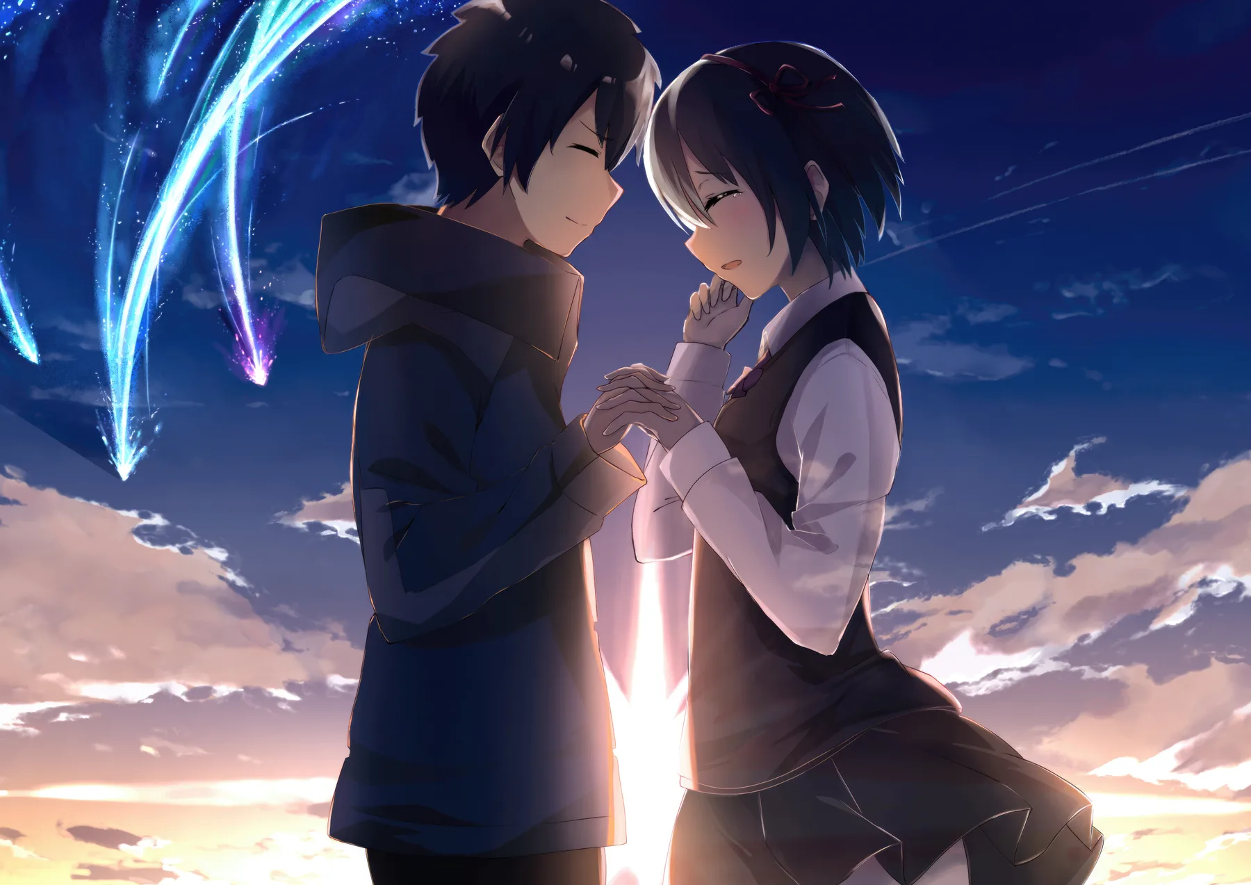 Taki y Mitsuha tomados de las manos bajo el cometa